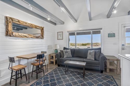 a living room with a couch and a table at Driftwood Resort on the Ocean in Montauk