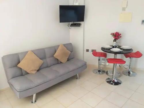 a living room with a couch and a table at Panoramic Holidays - Premium 8 in Peyia
