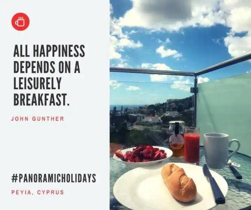 a table with a plate of food on a balcony at Panoramic Holidays - Premium 8 in Peyia