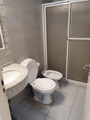 a bathroom with a toilet and a sink and a shower at fucsia in Rosario