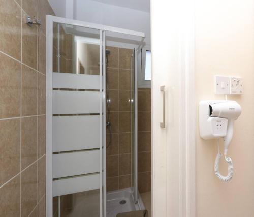 a bathroom with a shower with a toilet paper dispenser at Panoramic Holidays - Premium 9 in Peyia