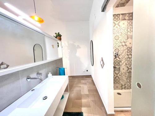 une salle de bain blanche avec lavabo et douche dans l'établissement Villa di Nera Apartments, à Palerme