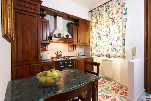 a kitchen with a bowl of fruit on a counter at Delfini Trevi House in Rome