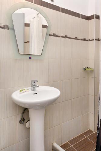 a bathroom with a sink and a mirror at Hotel Villa Plaza in Spetses