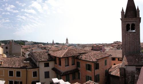 a view of a city with a clock tower and roofs at Hotel Accademia in Verona