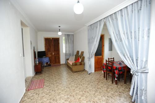 a living room with a couch and a table at chelo in Ambrolauri