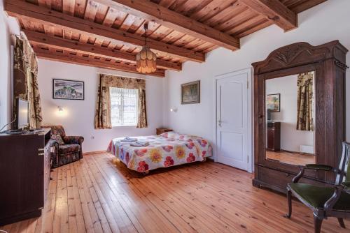 a bedroom with a bed and a large mirror at Vila Jelita in Nida