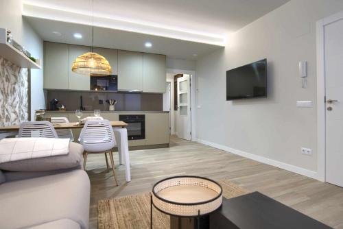 a living room and kitchen with a couch and a table at Apartamento rural Las Cañas Esencia de Bardenas in Villafranca