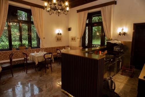 a dining room with a table and a chandelier at VILA HERBERSTEIN in Velenje