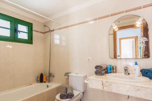 a bathroom with a sink and a toilet and a tub at Villa Plata by Villa Plus in Puerto del Carmen