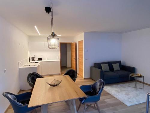 a living room with a table and chairs and a couch at Cosy Apartment Marlain-Self Check in in San Valentino alla Muta