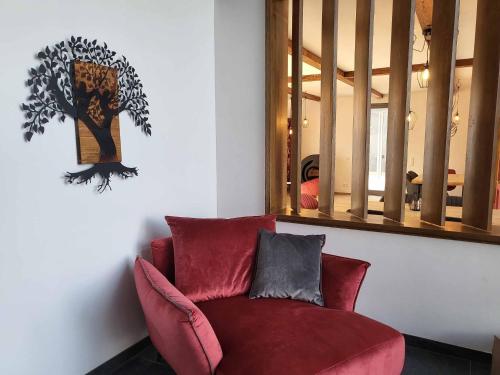 a red chair in a room with a mirror at Ferienhof Gutmichel in Feuchtwangen