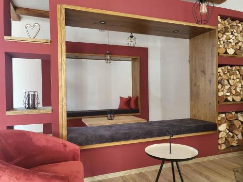 a room with a mirror and a couch and a chair at Ferienhof Gutmichel in Feuchtwangen
