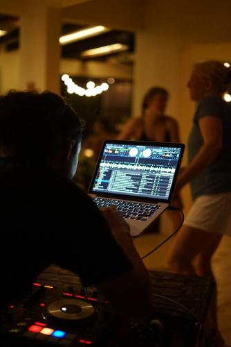 a man sitting in front of a laptop computer at ONDA - Playa Grande - Adults Only in Playa Grande