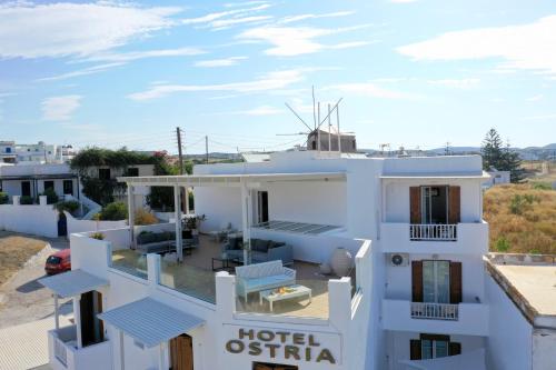 a white house with a hotel insignia at Ostria Hotel  in Adamas