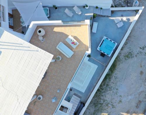 an overhead view of a house with a swimming pool at Ostria Hotel  in Adamas