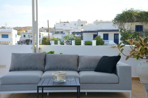 a couch in a living room with a table at Ostria Hotel  in Adamas