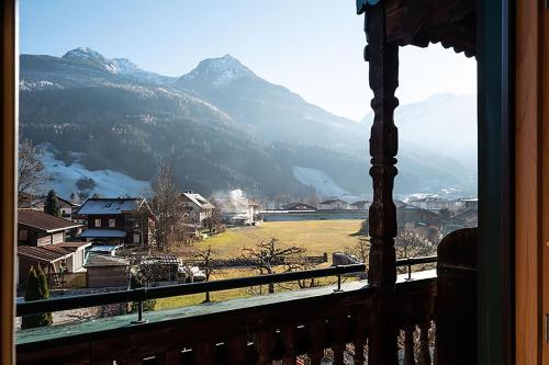 a view of a mountain range from a window at Hotel Senningerbräu in Bramberg am Wildkogel