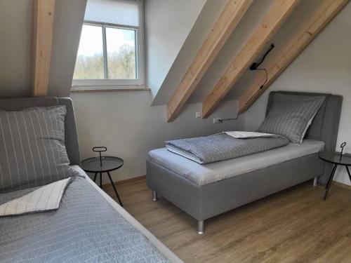 a bedroom with a bed and two tables at Ferienhof Gutmichel in Feuchtwangen