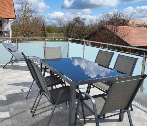a blue table and chairs on a patio at Ferienhof Gutmichel in Feuchtwangen