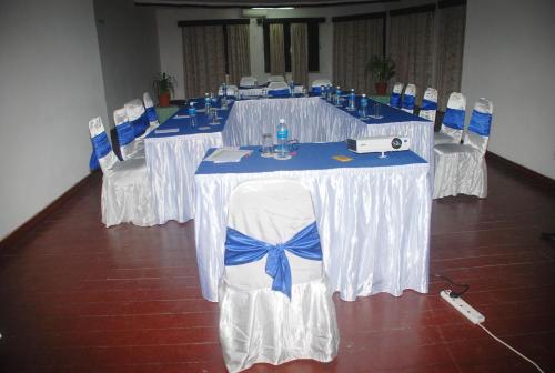 a group of tables with blue and white table cloths at Bamburi Beach Hotel in Bamburi