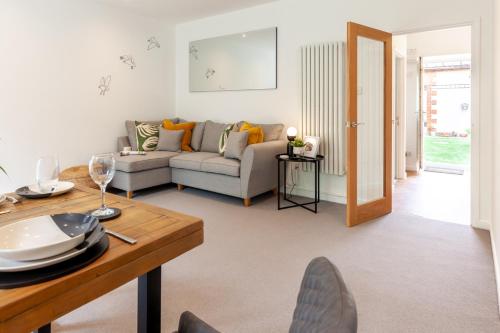 a living room with a couch and a table at No 5 Highwayman - Norfolk Cottage Agency in Sheringham