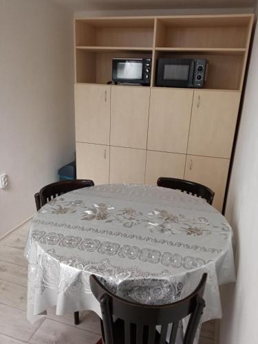 a dining room table with a white table cloth on it at Apartmán Hulín, Chrášťany in Hulín