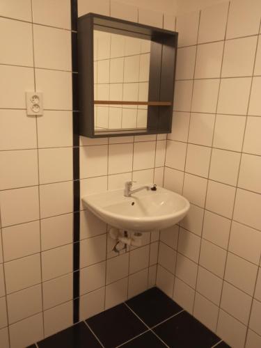 a bathroom with a sink and a mirror at Apartmán Hulín, Chrášťany in Hulín