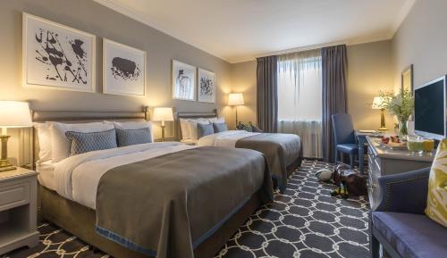 a hotel room with two beds and a television at Castletroy Park Hotel in Limerick