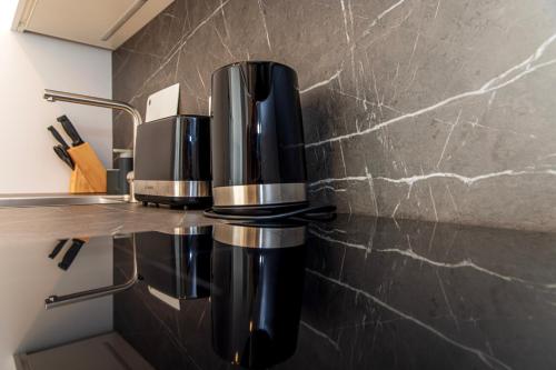 a coffee machine sitting on a counter in a kitchen at Sunset Apartment at Sventosios Vartai in Palanga