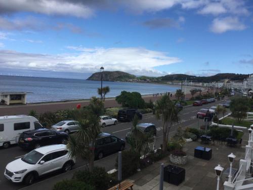 a view of a parking lot next to the ocean at THE TREVONE, Llandudno in Llandudno