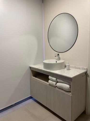 a bathroom with a sink and a mirror at Departamentos boutique in La Falda
