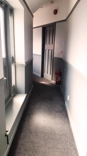 an empty hallway with a door in a room at The Royal Oak Duddington in Stamford