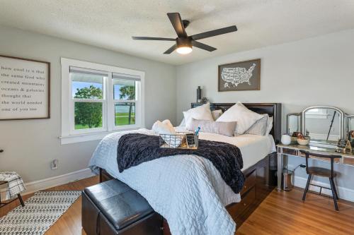 a bedroom with a bed with a ceiling fan at Historic Waterfront estate With Yard & Modern Kitchen in Lake Worth
