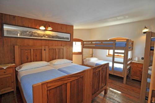a bedroom with two bunk beds and a desk at Rifugio Garibaldi in Passo Stelvio