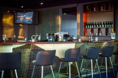 a bar with blue stools in a restaurant at Parkhotel Heilbronn in Heilbronn