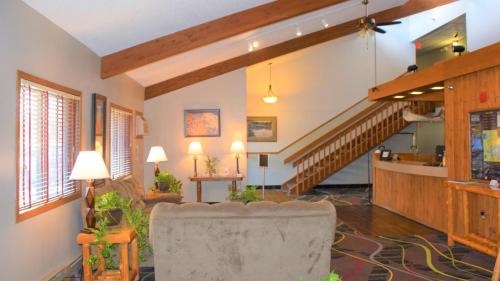 a living room with a staircase and a chair at Walker Hotel in Walker