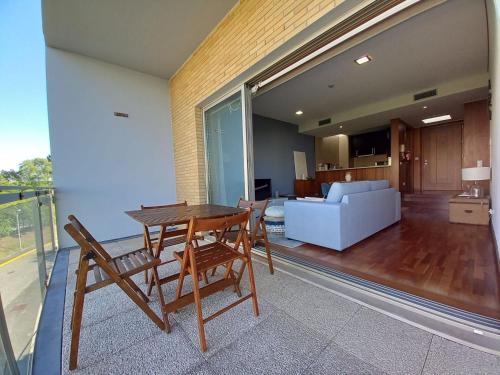 a living room with a table and chairs and a couch at Cabedelo Beach Apartment in Viana do Castelo