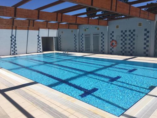 a large swimming pool with blue water at Cabedelo Beach Apartment in Viana do Castelo