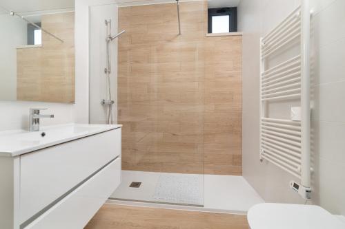 a bathroom with a shower and a white sink at Casa do Sol - By SCH in Salir de Porto