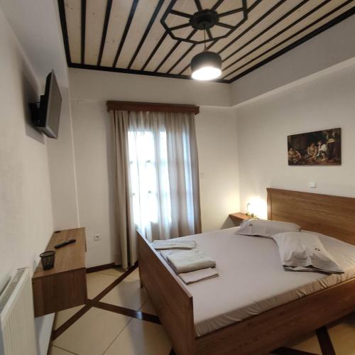 a bedroom with a large bed and a ceiling at Vrionis House in Agios Dimitrios
