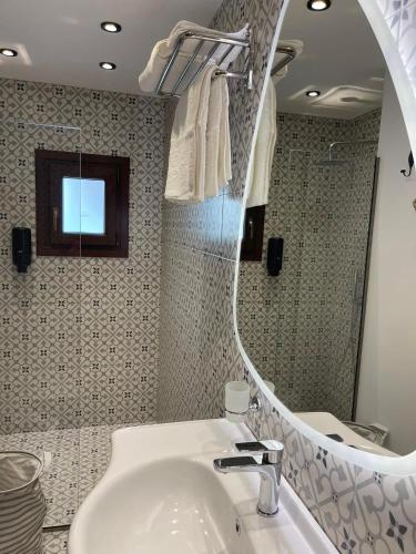a bathroom with a sink and a mirror at Utopia Luxury Suites - Old Town in Rhodes Town