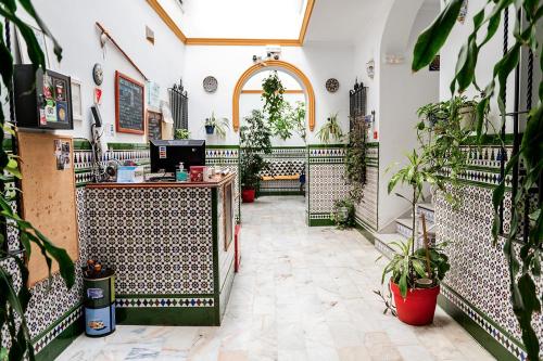 a large room filled with lots of green plants at Hostel Triana Backpackers in Seville