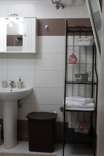 a bathroom with a sink and a towel rack at Anemone City Center Apartment in Heraklio