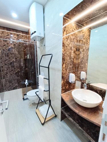 a bathroom with a sink and a shower at KARAULA Apartments in Sarajevo