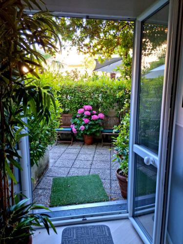 a view of a patio through a sliding glass door at Victoria Royal Garden in Como