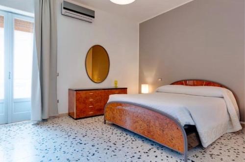 a bedroom with a large bed and a mirror at MeryTes - Casa vista mare in Crotone