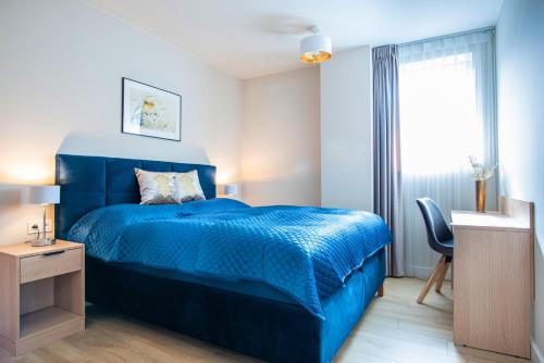 Ένα ή περισσότερα κρεβάτια σε δωμάτιο στο Harmonia Apartamenty Ustroń