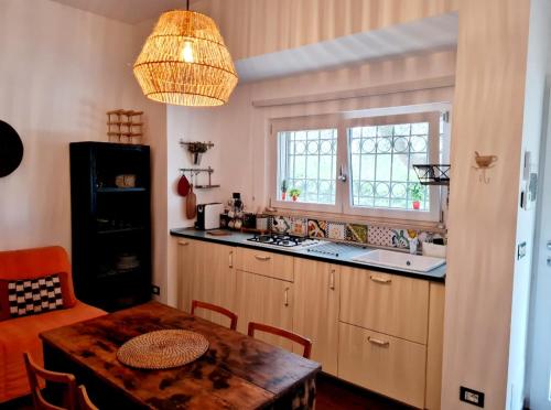 a kitchen with a table and a kitchen with a window at Eva Luna in Ostuni