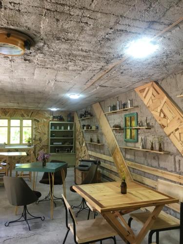 a dining room with wooden tables and chairs at Apple Tree Family Home (ECO) in Dzorakap
